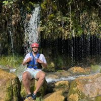 Rafter taking a rest after adventure with RIO RAFTING team Taking a break under waterfalls