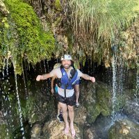 Tourists rafting in the untouched nature of the Cetina River Enyoing some waterfalls during rafting tour