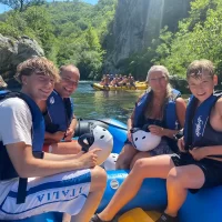 Experience the thrill of river rafting near Split, Croatia, where breathtaking natural beauty meets exhilarating adventure Family on a rafting trip near omiš