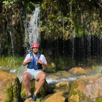 Rafter taking a rest after adventure with RIO RAFTING team Taking a break under waterfalls
