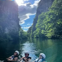 A group enjoys the combination of adrenaline and untouched Dalmatian nature Tourists swimming in a canyon of Cetina river