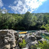 Rafting instructor alone on a boat on beautiful River Cetina slowly and carefully sailing