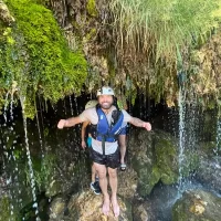 Tourists rafting in the untouched nature of the Cetina River guests enjoying some waterfalls during rafting tour