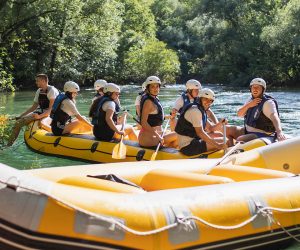 Several rafting boats ready for adventure lined up on the rocky shore of the Cetina River near Omiš. Rafting boats lined up on the shore before starting the trip on Cetina