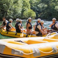 Several rafting boats ready for adventure lined up on the rocky shore of the Cetina River near Omiš. Rafting boats lined up on the shore before starting the trip on Cetina