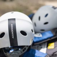 Essential protective rafting equipment—helmets and life jackets—prepared for the adventure on the Cetina River. Protective rafting gear including helmets and life jackets ready for use